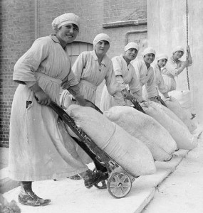 Female workers pose with trolleys laden with sacks of flour in the grounds of the mills of Rank and Sons, Birkenhead, Cheshire, in September 1918.