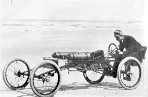 Ransom E. Olds in the Olds Pirate racing car at Ormond Beach, Florida in 1896 or 1897.