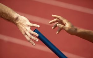 Relay Runner Passing Baton off to Next Runner