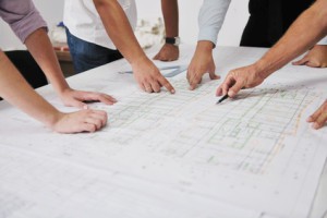 Team of architects people in group on construciton site check documents and business workflow