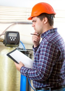 Portrait of troubled engineer in hard hat at factory