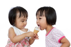 Asian Little Chinese Girls Eating Ice Cream isolated on White Background