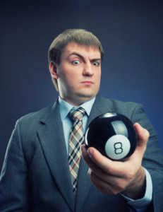 Businessman holding magic ball with number 8