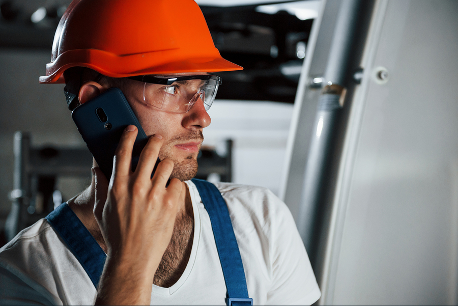 Worker in Factory making a Phone Call