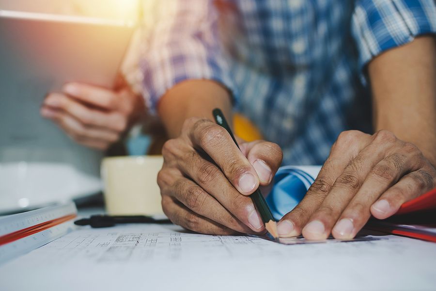Engineering hands and blueprint